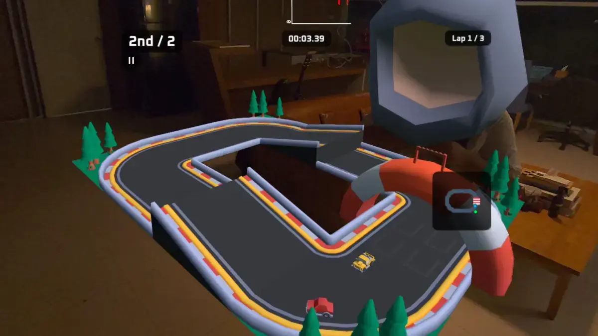 First-person passthrough view inside a Quest in Shed Racer: a miniature racing track sits on a real table, with a floating helmet representing another colocated player hovering over the far side of the track